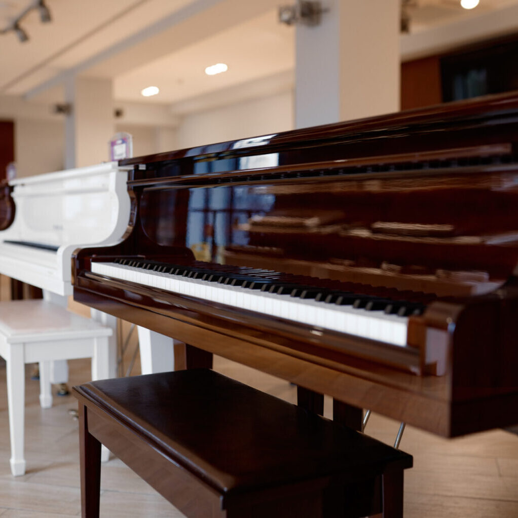 Piano shop background with many modern or vintage keyboards musical instrument display. Art studio or workshop retail sale concept